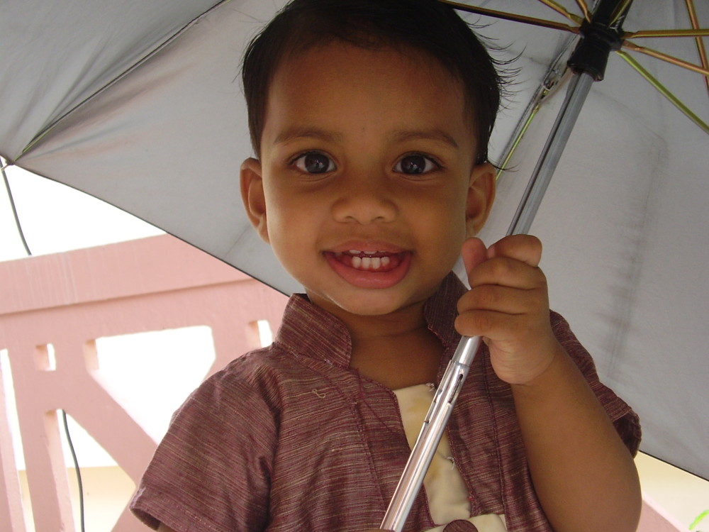 Closeup shot of Sreekutty with Umbrella